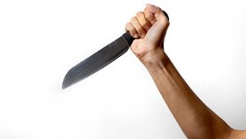 Girl's hand holding a knife, apparently not in food prep