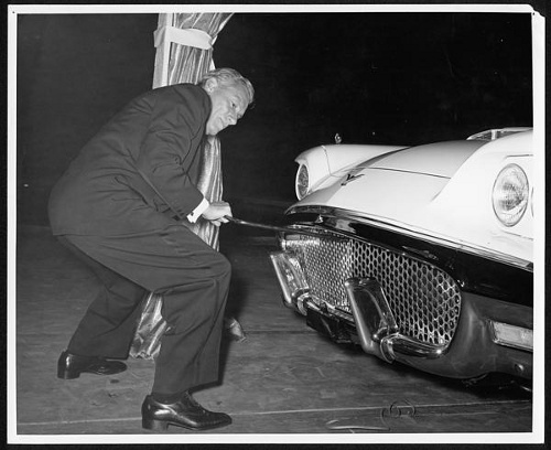 Hoagy Carmichael pretends to crank start a car