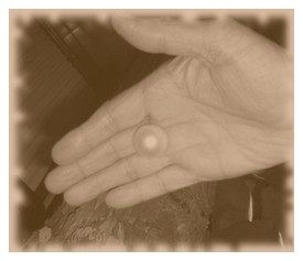 Man's open hand holding pearl